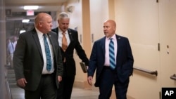 From left, Rep. Glenn Thompson, R-Pa., Rep. Steve Womack, R-Ark., and Rep. Tom MacArthur, R-N.J., walk to a closed-door GOP meeting in the basement of the Capitol as the Republican leadership tries to reach a policy agreement between conservatives and moderates on immigration, in Washington, June 7, 2018. 