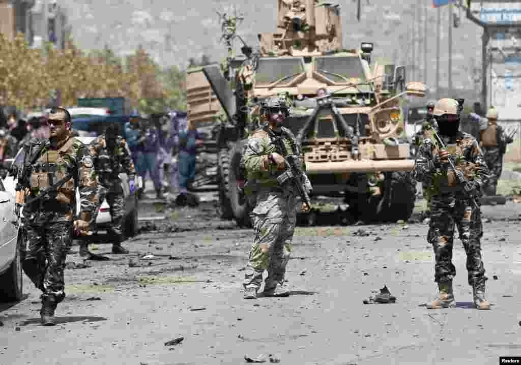 NATO troops arrive at the site of a suicide car bomb attack in Kabul. A suicide car bomber targeted a convoy of foreign forces in the capital, killing at least four Afghan civilians, including children, and wounding dozens, Afghan security officials said.