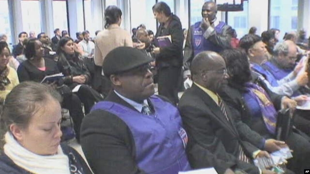 Haitian immigrants learn about a new immigration program for Haitians living in the United States at the Federal Building in Manhattan, New York