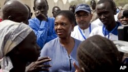 United Nations Under-Secretary-General for Humanitarian Affairs and Emergency Relief Coordinator for South Sudan, Valerie Amos, engages with local government officials and humanitarian aid workers in the village of Walgak, South Sudan on Thursday, Feb. 2,