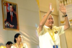 FILE - Prince Norodom Ranariddh (R) greets party's members during a Funcinpec party congress, in Phnom Penh, Cambodia, Jan. 19, 2015.