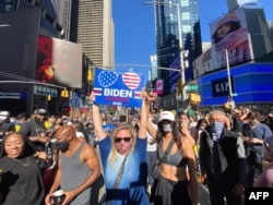 People celebrate at Times Square in New York City after Joe Biden was projectd the winner of the 2020 presidential election, Nov. 7, 2020.