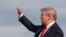 President Donald Trump gestures as he disembarks Air Force One upon arrival at Wheeling, West Virginia, July 24, 2019. 