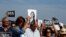 People attend three minutes of silence as they gather at the site where anti-corruption journalist Daphne Caruana Galizia was assassinated in a car bomb one year ago, in Bidnija, Malta October 16, 2018. 