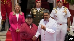 El presidente venezolano, Nicolás Maduro, a la derecha, y el presidente de Nicaragua, Daniel Ortega, se dan la mano ante fotógrafos al inicio de una cumbre de ALBA en el palacio presidencial de Miraflores en Caracas, Venezuela, el miércoles 24 de abril de 2024. AP