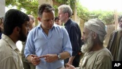 Mark Sedwill, center, NATO senior civilian representative in Afghanistan, talks to locals in Marjah, Afghanistan's Helmand province (FILE)