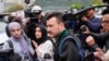 FILE - Members of the Columbia University Apartheid Divest group, including Mahmoud Khalil, center, are surrounded by members of the media outside the Columbia University campus, April 30, 2024, in New York.