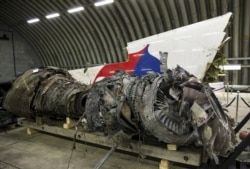 FILE - Wreckage of the MH17 airplane is seen after the presentation of the final report into the crash of July 2014 of Malaysia Airlines Flight MH17 over Ukraine in Gilze Rijen, the Netherlands, Oct. 13, 2015.