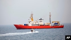 In this photo taken on Friday, June 1, 2018 the rescue vessel Aquarius ship approaches the Pozzallo harbor, Southern Italy. Spain stepped up June 11, 2018 and offered to take in a rescue ship carrying more than 600 migrants.