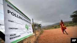 FILE - A Masaai walks to a polling station to vote in general elections in Kumpa, Kenya, March 4, 2013.