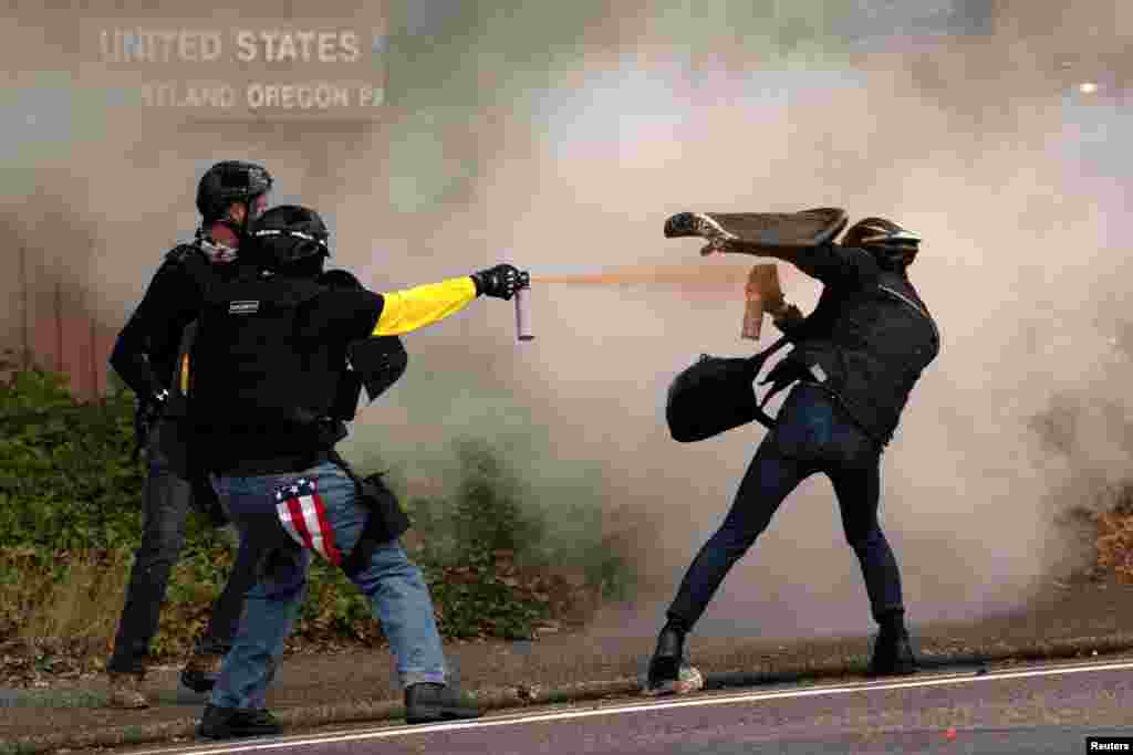 Members of the far-right Proud Boys clash with counter-protesters during rival rallies in Portland, Oregon, Aug. 22, 2021.