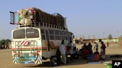 Southern Sudanese from Abyei, who have resided in the north for 21 years, wait next to a bus in Khartoum, for a trip back to the Abyei oil region (File Photo)