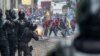 Demonstrators clash with riot police as thousands march against Ecuadorean President Lenin Moreno&#39;s decision to slash fuel subsidies, in Quito.