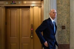 FILE - Republican Senator Rick Scott waits for an elevator on Capitol Hill in Washington, Feb. 5, 2020.