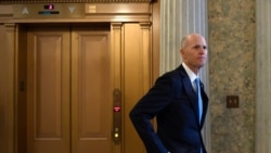 FILE - Republican Senator Rick Scott waits for an elevator on Capitol Hill in Washington, Feb. 5, 2020.