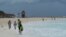 Tourists stand on a beach as Tropical Storm Helene approaches the Yucatan Peninsula, in Cancun, Mexico Sept. 24, 2024. 