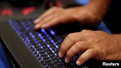 FILE — A man types on a keyboard during the Def Con hacker convention in Las Vegas, July 29, 2017. The U.S. government on Thursday unveiled measures to combat Russian hackers accused of targeting U.S-based entities and individuals and meddling in a British election.