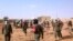 Soldiers attend to wounded and casualties in the aftermath of a suicide bomb attack who ripped through a camp grouping former rebels and pro-government militia in troubled northern Mali Jan. 18, 2017 in Gao. 