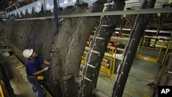 An employee works on a jig for a Boeing 767 at Mitsubishi Heavy Industries' Tobishima plant of its Nagoya Aerospace Systems Works in Nagoya, central Japan September 22, 2010.