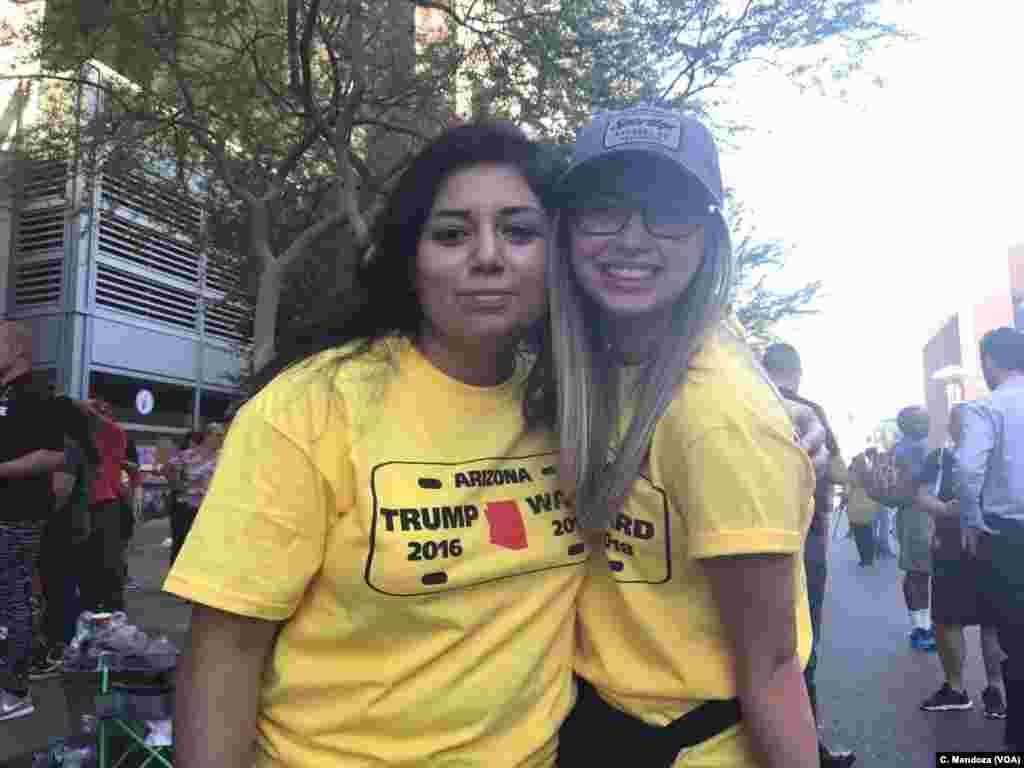 Young girls for President Donald Trump show their custommade T-shirts, in Phoenix, Aug. 22, 2017. 