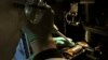 FILE - A researcher injects DNA material onto a laboratory dish.