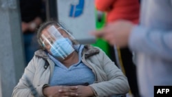 Relatives of patients suspected of having the novel coronavirus wait at the COVID-19 triage area of the General Hospital in Mexico City on Dec. 13, 2020. 