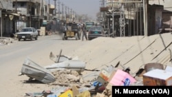 FILE - Areas around Old Mosul, Iraq, are slowly being repopulated, but many places are entirely without electricity, running water and other city services, like trash collection, Aug. 27, 2017.