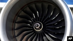 FILE - The blades of a huge Rolls Royce engine on an Airbus A350 XWB test flight aircraft, parked at Newark Liberty international airport in Newark, N.J. 