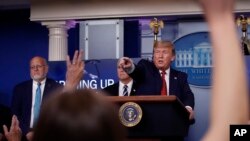 FILE - President Donald Trump points to a reporter to ask a question as he speaks about the coronavirus in the James Brady Press Briefing Room of the White House, in Washington, April 16, 2020.