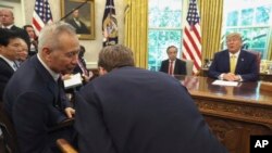 FILE - In this Friday, Oct. 11, 2019, file photo, President Donald Trump watches as Chinese Vice Premier Liu He speaks to U.S. Trade representative Robert Lighthizer, right, in the Oval Office of the White House in Washington.