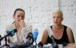 Belarusian united opposition candidate Sviatlana Tsikhanouskaya and Maria Kolesnikova, a representative of politician Viktor Babariko's campaign office, attend a news conference following the presidential election in Minsk, Belarus Aug. 10, 2020.