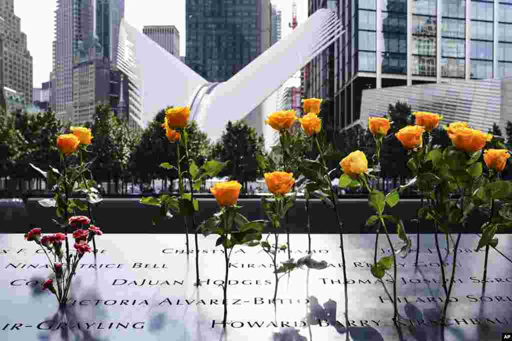 Flowers are placed in the inscribed names of the deceased at the National September 11 Memorial and Museum, Friday, Sept. 11, 2020, in New York. (AP Photo/John Minchillo)