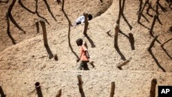 Children walk on the Askia mausoleum, built in 1495 in Gao, northern Mali, February 15, 2013, one week after a suicide bomber on a motorcycle killed himself attempting to blow up an army checkpoint at the entrance of the town. 