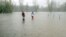 Pouring rain in the floodwaters of the Tittabawassee River in Saginaw Township, Mich.