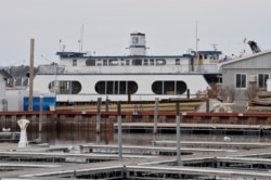 A ferry sits in Burlington Bay, Lake Champlain, in Burlington, Vermont on March 11, 2020.