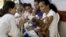 FILE - Mothers with their children, who have microcephaly, await medical care at the Hospital Oswaldo Cruz, in Recife, Brazil, Jan. 26, 2016. 
