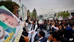 Supporters gather outside the National Assembly to celebrate Prime Minister Imran Khan winning a vote of confidence in Islamabad, Pakistan, March 6, 2021.