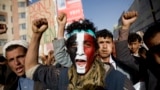 FILE - A Houthi Shi'ite rebel with Yemen's flag painted on his face chants slogans during a rally in the capital, Sana'a, Yemen.