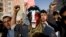FILE - A Houthi Shi'ite rebel with Yemen's flag painted on his face chants slogans during a rally in the capital, Sana'a, Feb 27, 2015.