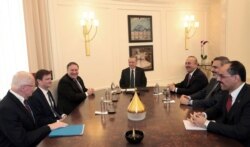 FILE - Turkey's President Recep Tayyip Erdogan, center, U.S. Secretary of State Mike Pompeo, U.S. Special Representative for Syria Engagement James Jeffrey, and Turkey's Foreign Minister Mevlut Cavusoglu, at Esenboga Airport in Ankara, Oct. 17, 2018.