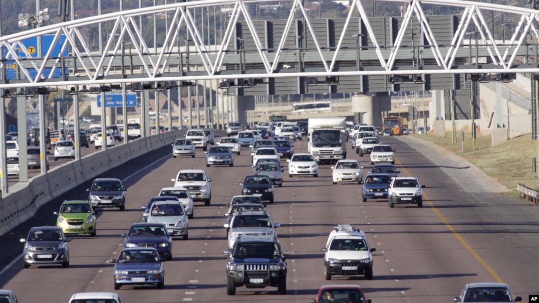 Cars stream underneath a gantry on a road to Pretoria, South Africa, May 4, 2012. 