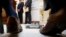 FILE- A model of a Mercedes-Benz sits in front of company officials as they wait to speak during a ceremony in Atlanta announcing the company's relocation of its U.S. corporate headquarters to Sandy Springs, Ga., from New Jersey, Feb. 3, 2015. German business leaders have expressed concerns that President Donald Trump's 25 percent tariff on imported steel could affect the auto industry in the South. 