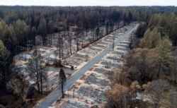 FILE- Homes leveled by the Camp Fire line the Ridgewood Mobile Home Park retirement community in Paradise, Calif., Dec. 3, 2018.