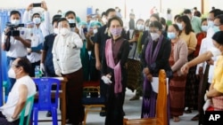 Myanmar leader Aung San Suu Kyi, center, inspects the vaccination processes to health workers at a hospital Wednesday, Jan.27, 2021, in Naypyitaw, Myanmar.