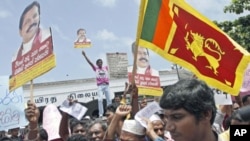 Sri Lankan government supporters hold placards against Britain's Channel 4 television during a protest in Colombo, Sri Lanka. Hundreds of government supporters, including state-run media journalists, protested Tuesday in Colombo against the UK channel wit