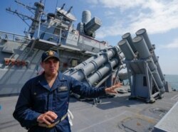 FILE - John D. John, commanding officer of guided-missile destroyer USS Ross, speaks to reporters during Sea Breeze 2021 maneuvers, in the Black Sea, July 7, 2021.