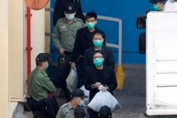 From top, Joshua Wong, Wu Chi-wai and Tam Tak-chi, some of the 47 pro-democracy Hong Kong activists, are escorted by Correctional Services officers in Hong Kong, March 2, 2021.