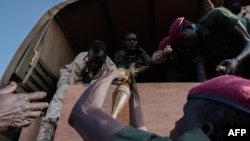 FILE - Rebel troops of the Sudan People's Liberation Army in Opposition (SPLA-IO) unload their weapons at their military site in Juba, Apr. 25, 2016.