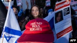 FILE - A pro-Israel counter protestor wearing a "Trump Was Right" hat, chants across a line of police officers towards a vigil organized by NYU students in support of Palestinians in Washington Square Park in New York City on October 17, 2023.