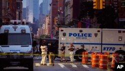 FILE - Members of the FBI and other law enforcement officers carry on investigations at the scene of Saturday's explosion in New York, Sept. 18, 2016. 